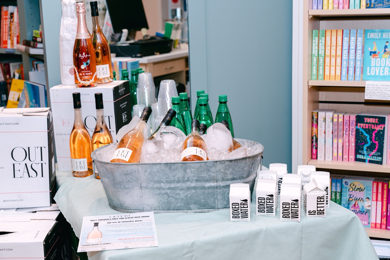 Rosé bottles chilled on ice alongside bottled water at the Moxies product launch in Greenwich.
